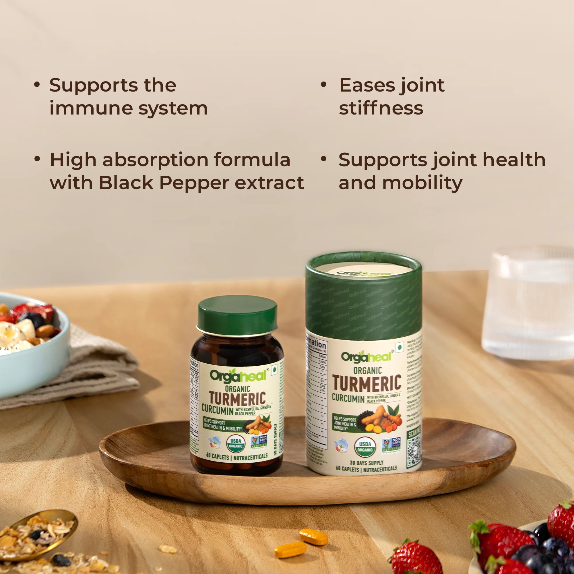 Two organic turmeric supplement containers on a wooden tray with text highlighting benefits.