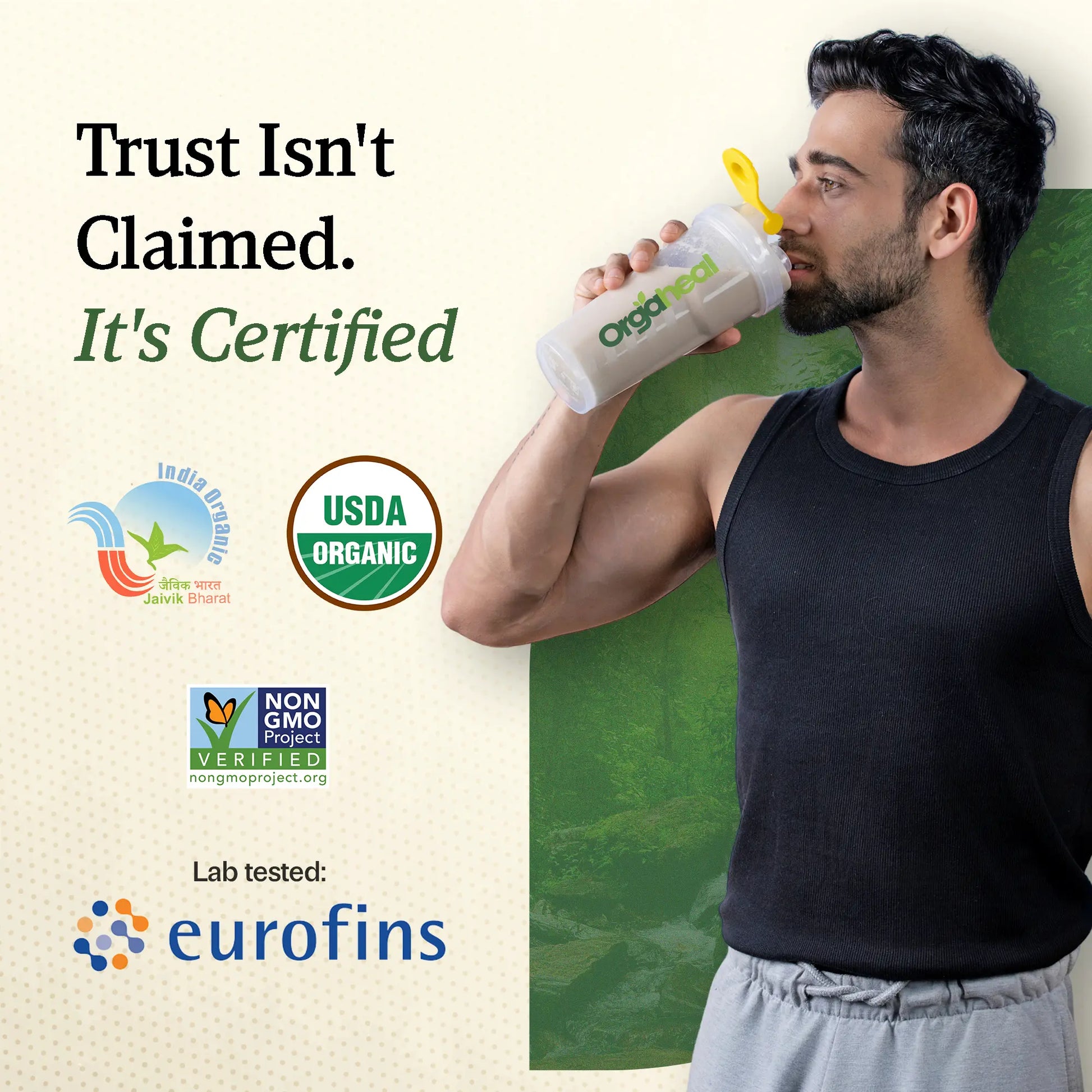 Man holding an Organic bottle with certification logos on a green background