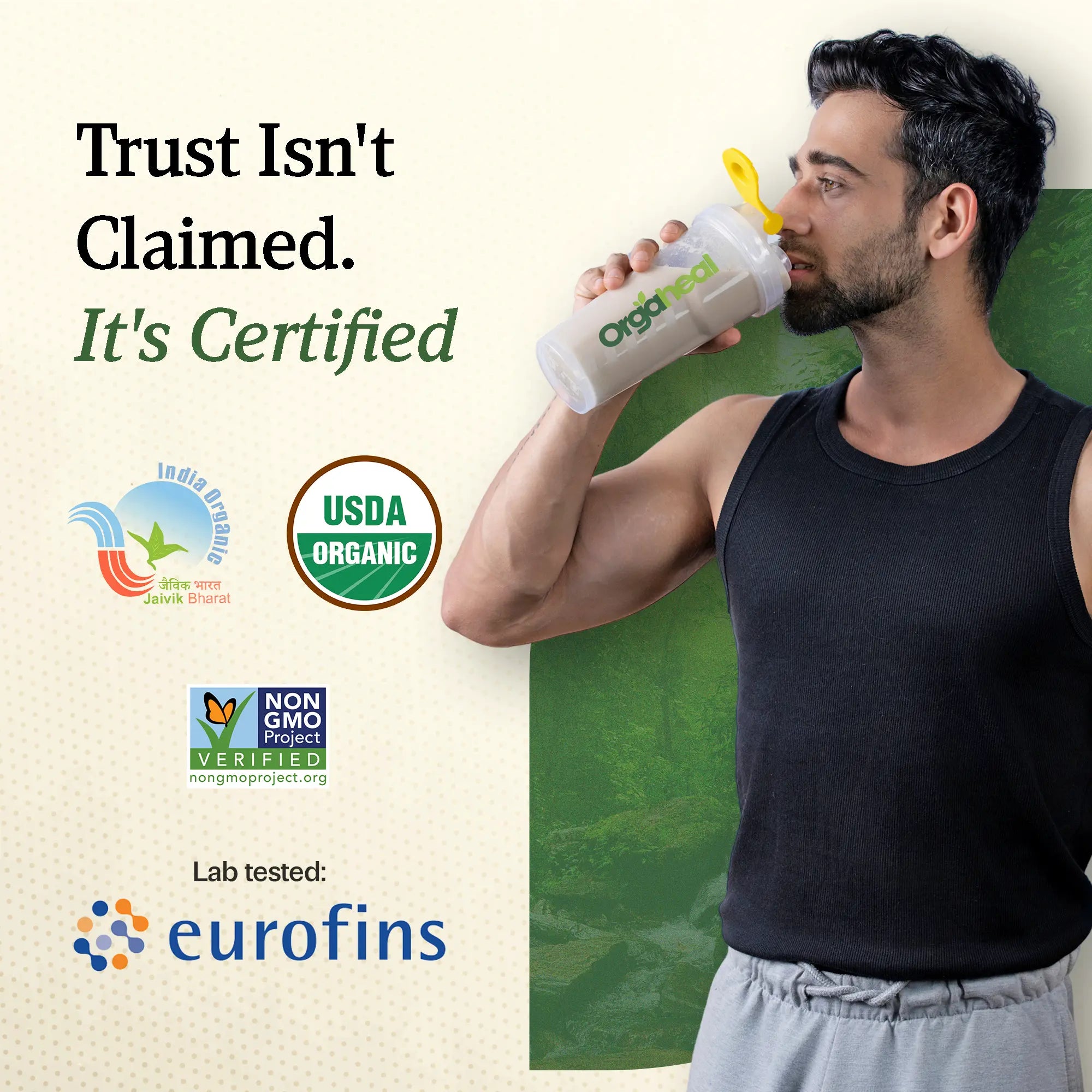 Man holding an Organic bottle with certification logos on a green background